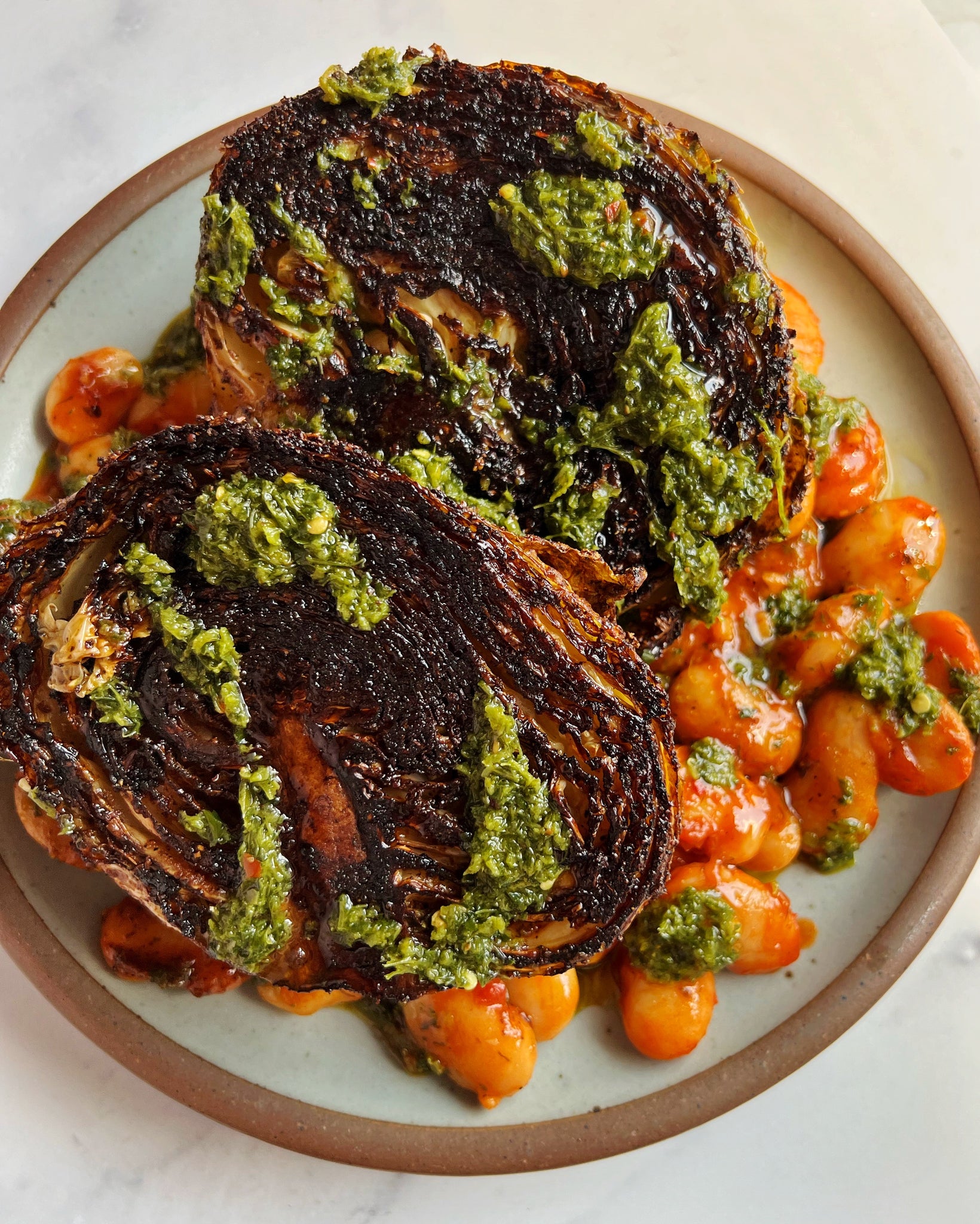 Savoy Cabbage “Shawarma” with Gigante Beans and Green Harissa